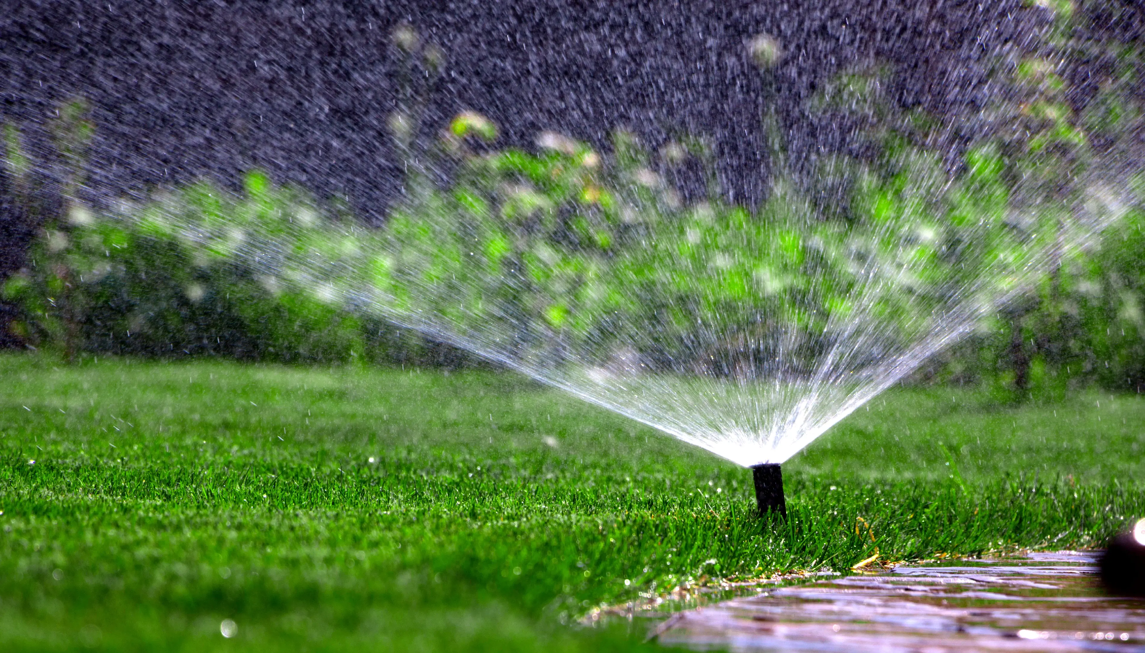 Automatic irrigation system on the background of green grass.