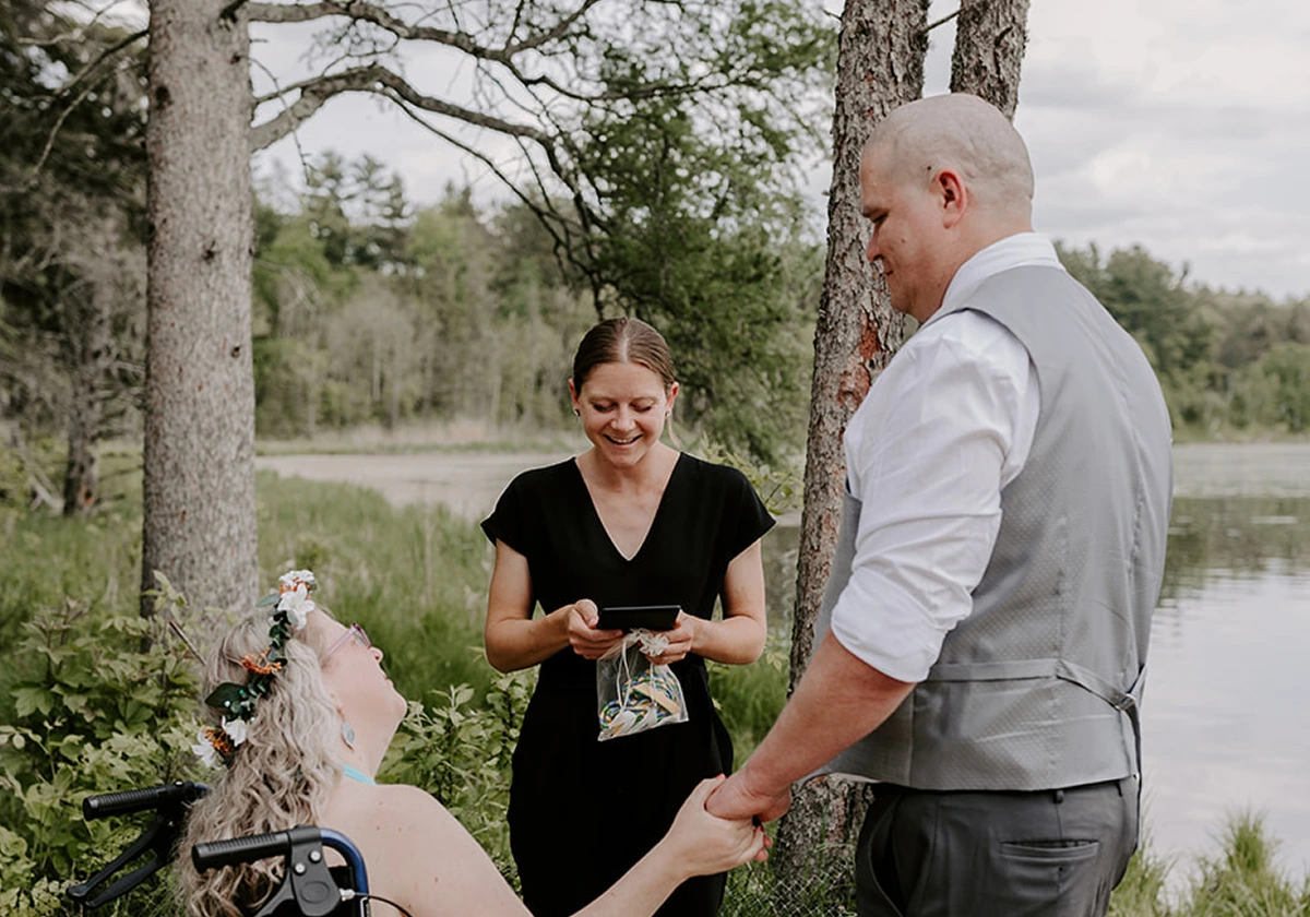 A photo of the couple in front of the officiant on a wedding ceremony