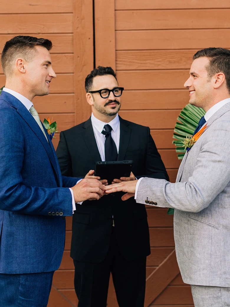 A photo of the couple in front of the officiant on a wedding ceremony