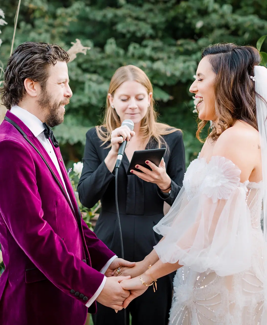 A photo of the couple in front of the officiant on a wedding ceremony
