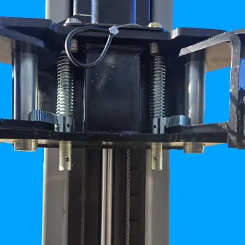 Close-up of mechanical system with metal springs, wires, and black metal components on a blue background.
