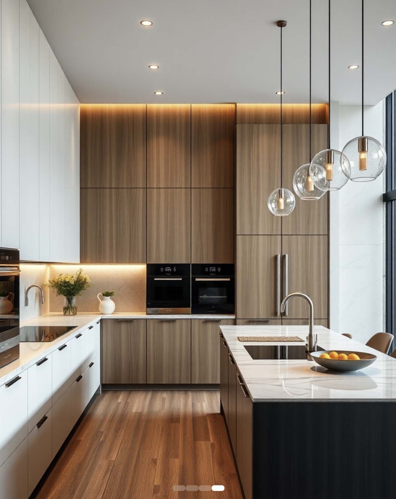 Modern kitchen with wood and white cabinetry, marble island, pendant lights, built-in ovens, and warm under-cabinet lighting.