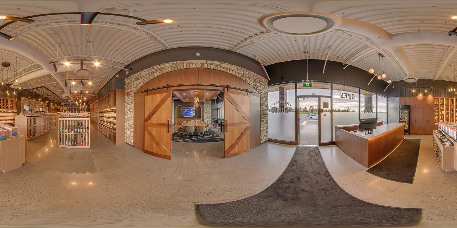 360° panorama of the shop entrance, showing the front counter, glass storefront, and arched stone surround with barn doors opening to the tasting room.