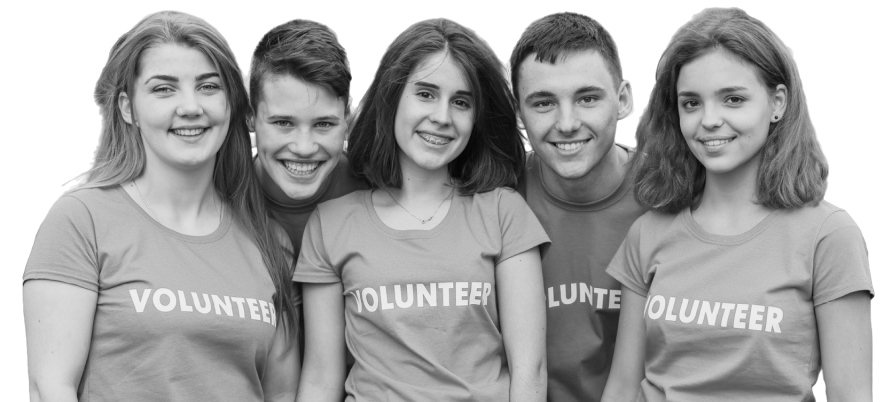 Group of five young volunteers wearing matching T-shirts smiling and standing close together.