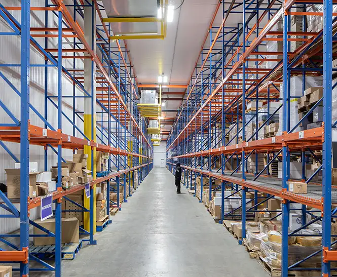 Blue wire warehouse shelves at the Gourmet Foods International factory