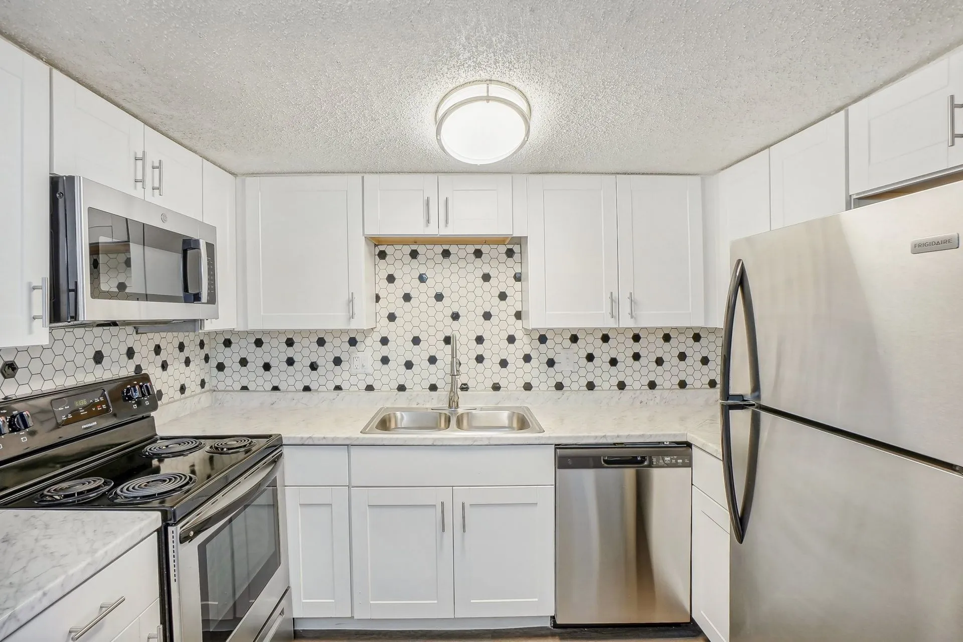 White kitchen with stainless steel appliances