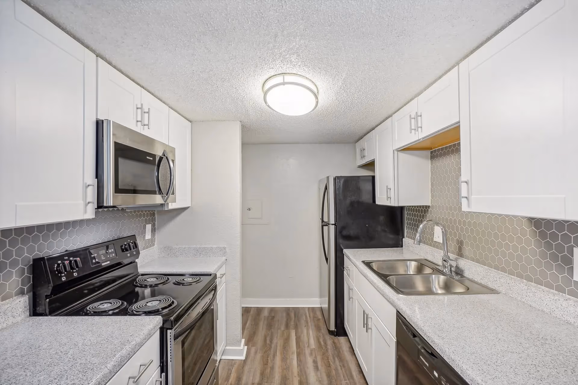 White kitchen with stainless steel appliances