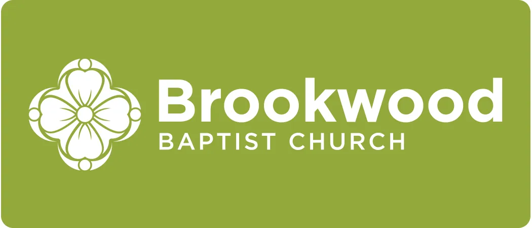 Brookwood Baptist Church logo with white floral emblem and text on green background.