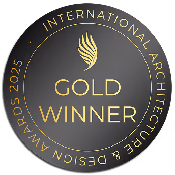 Medalla dorada redonda con texto 'International Architecture & Design Awards 2025' y 'Gold Winner' en el centro.