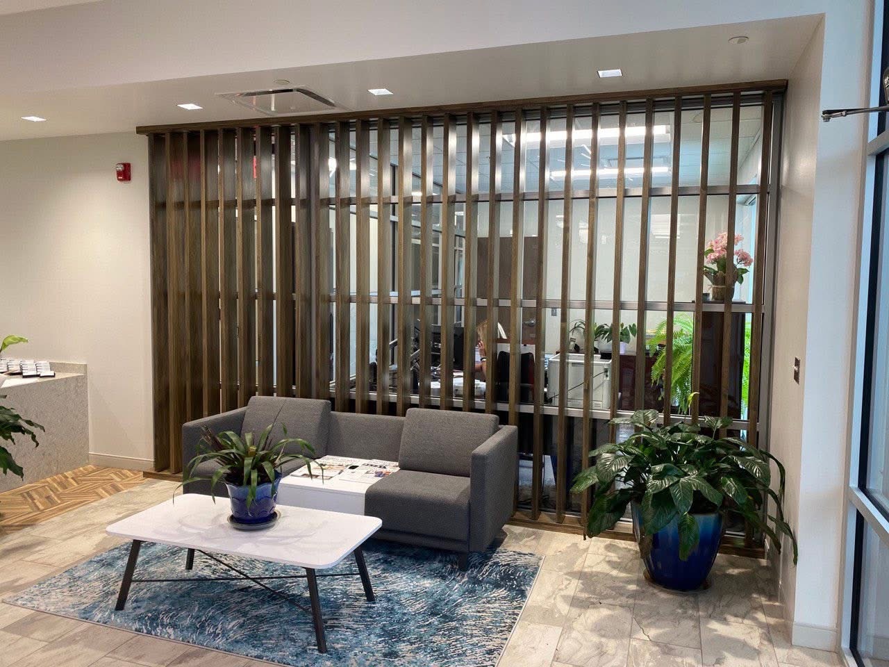 image of workers at machining station (for a manufacturing plant)