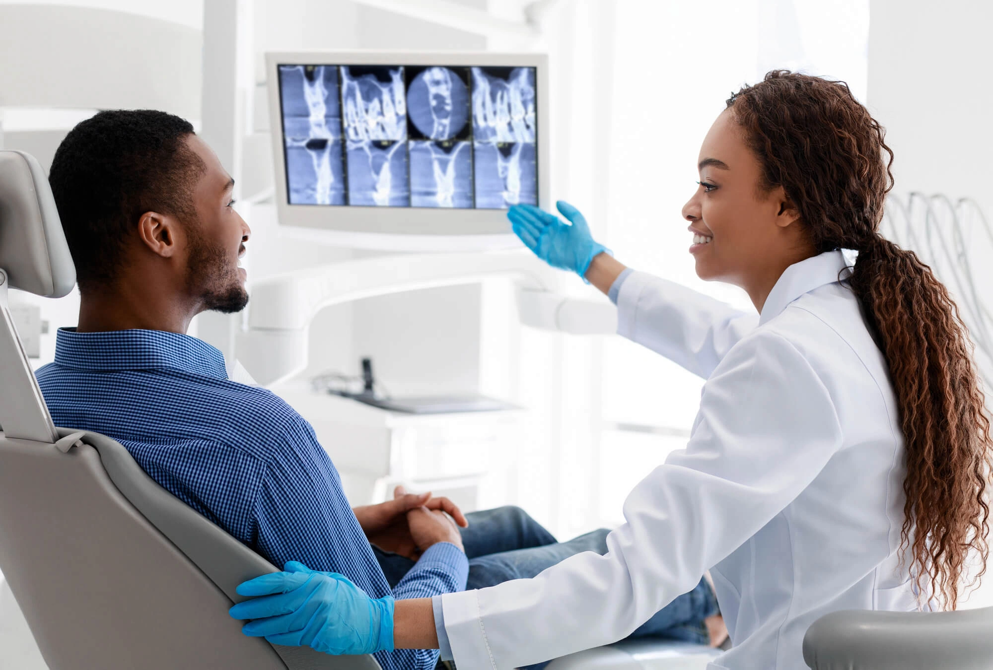 Patient and auburn dentists_ checking the xray