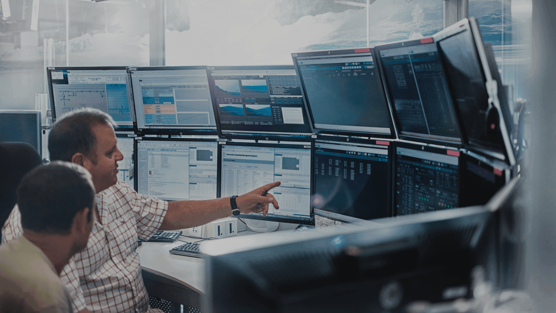 Man pointing to a monitor, symbolising the work to residence scheme visa