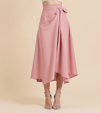 Woman wearing a strapless white top and a high-low pink skirt with a tied detail on one side, standing against a beige background.