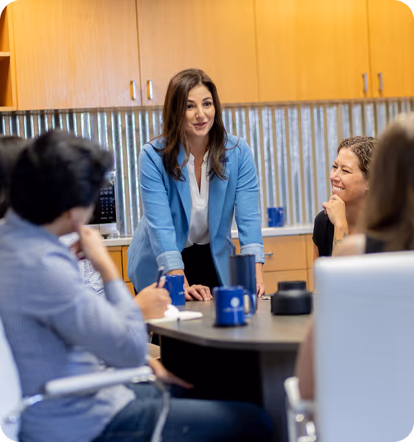 Pamela Garrett collaborating with her legal team around a conference table
