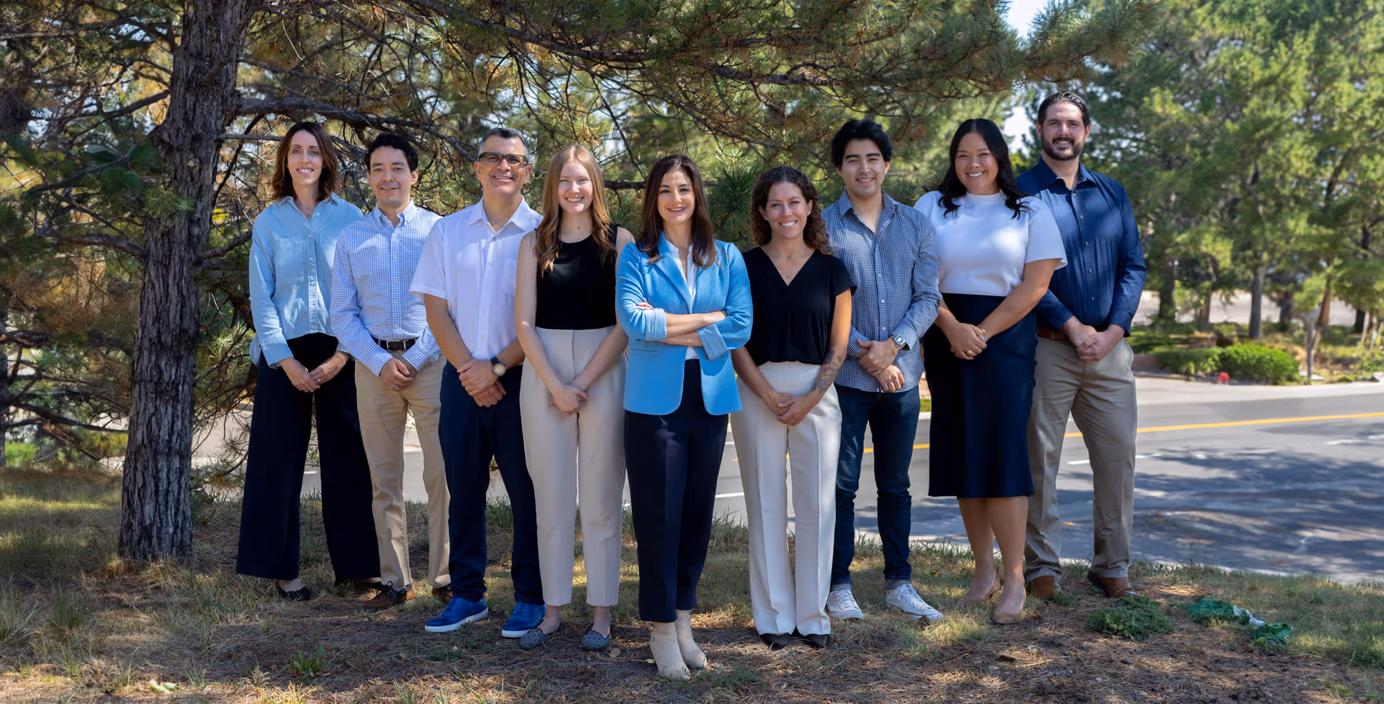 Pamela Garrett and Law Mother team pose for a photo outside