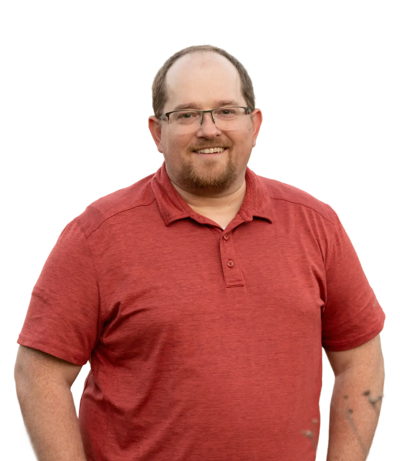 Smiling man with glasses and a beard wearing a red polo shirt.