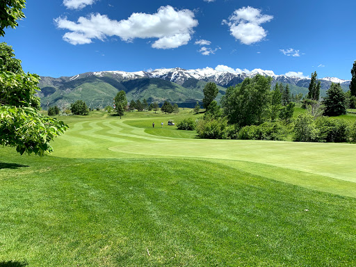 Man swinging a golf club to hit the golf ball