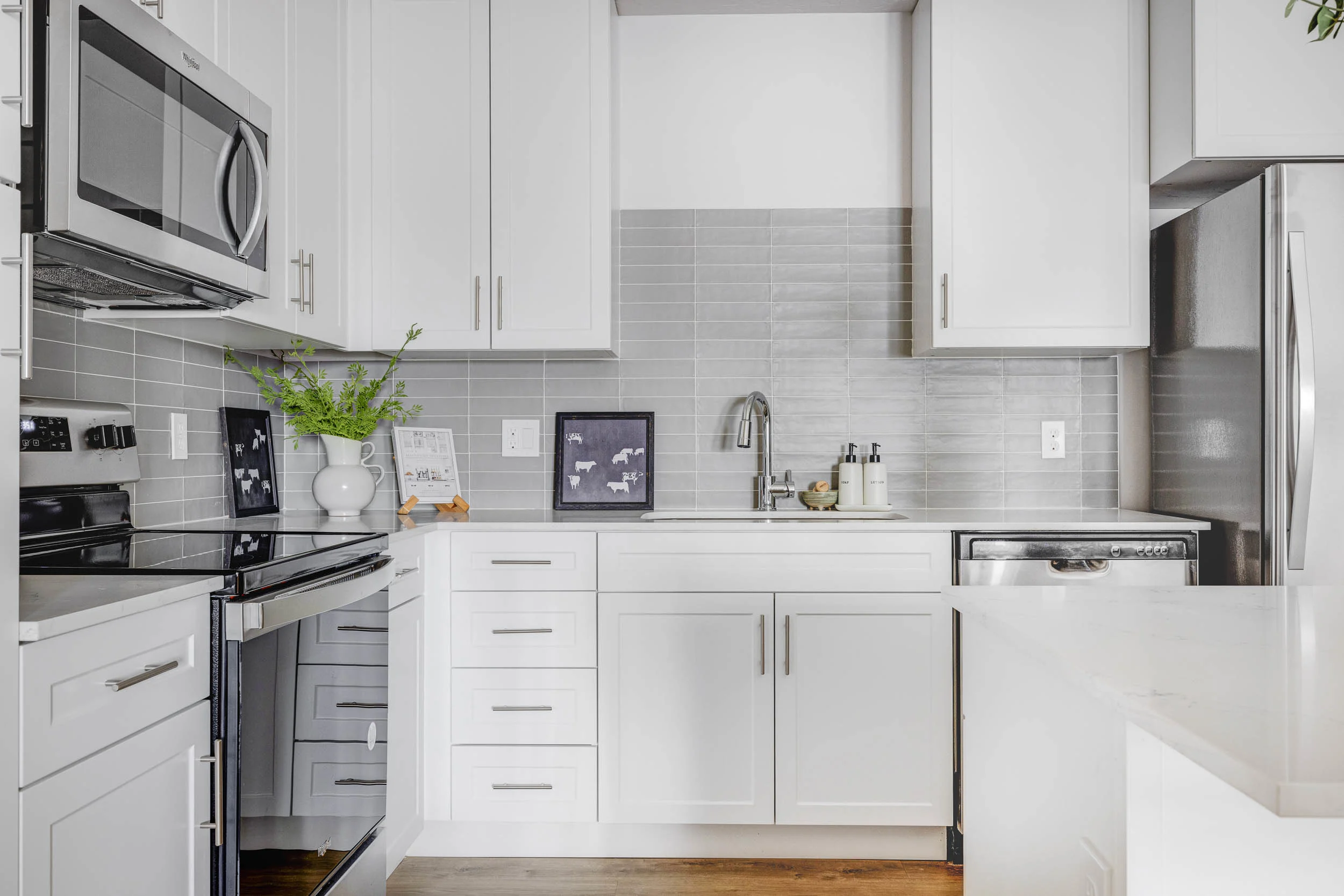 Kitchen with white cabinets and stainless steel appliances