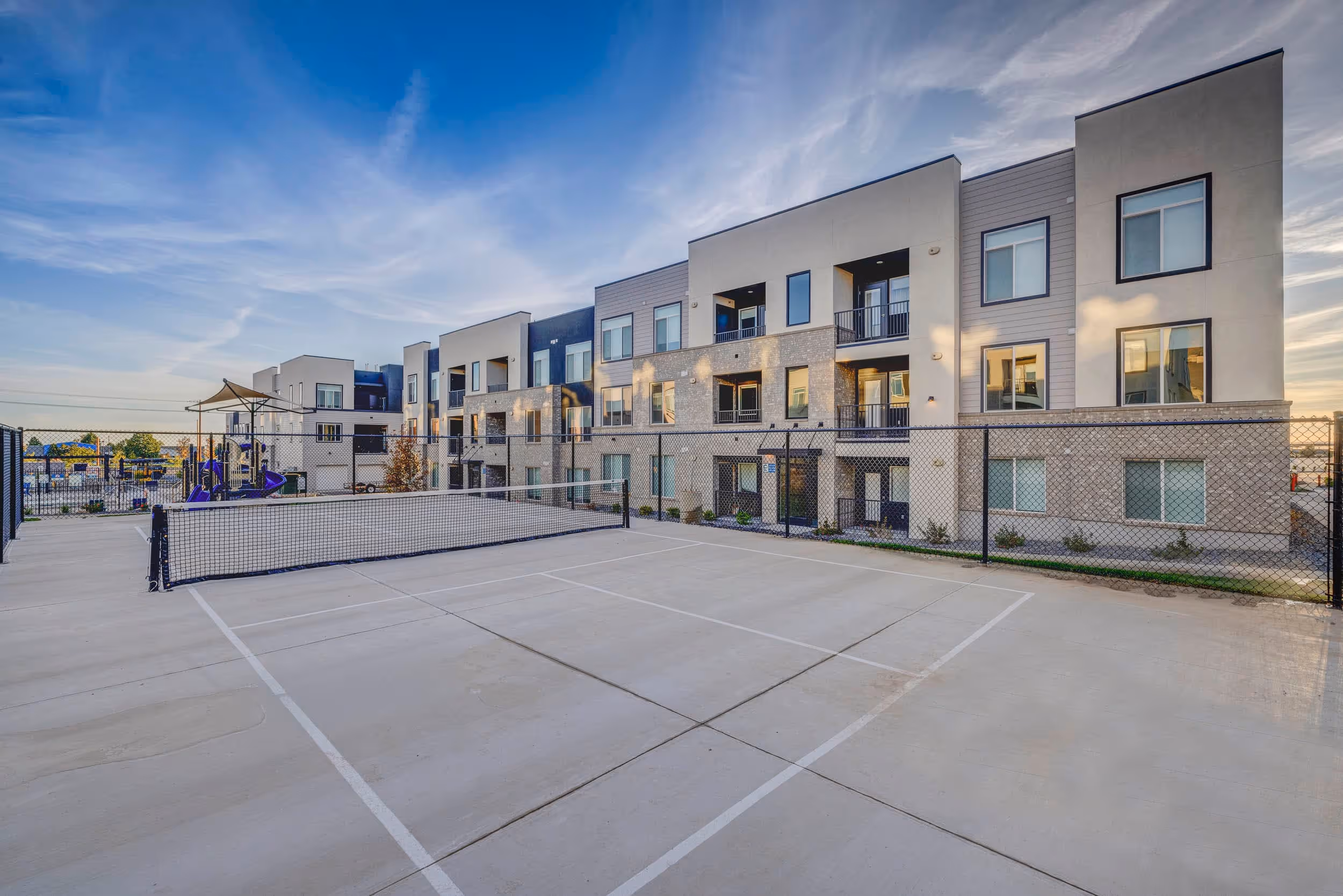 Pickleball court with apartment complex in the back