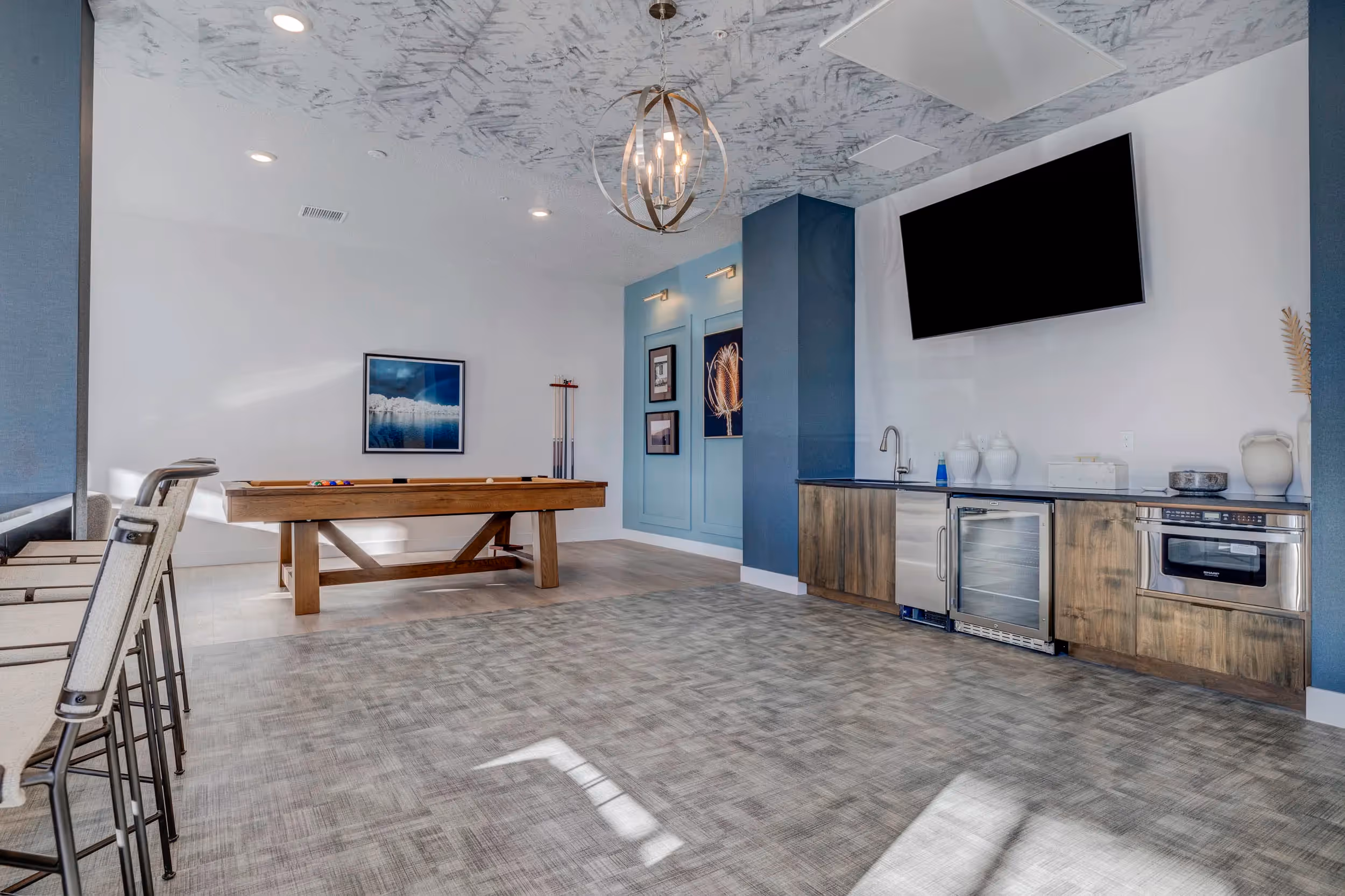 Clubhouse room with pool table, seating, and television on the room 