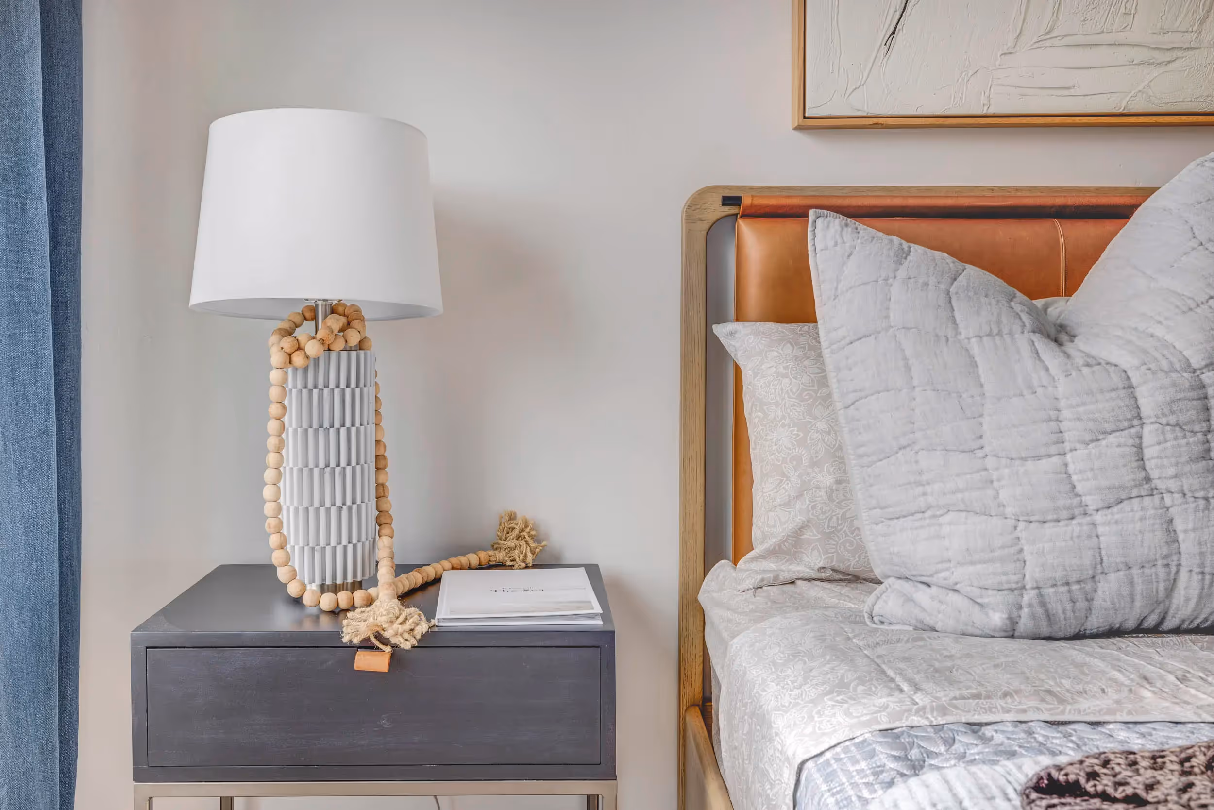 Close up view of bed and nighstand