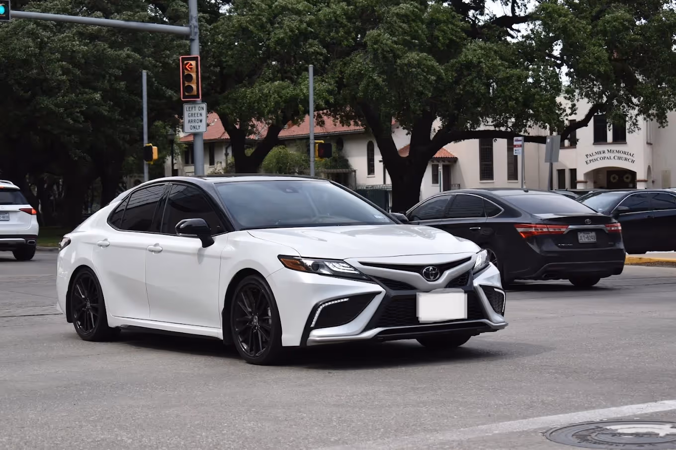 White Toyota Camry sedan with black wheels on a city street near Palmer Memorial Episcopal Church, RentUFS.