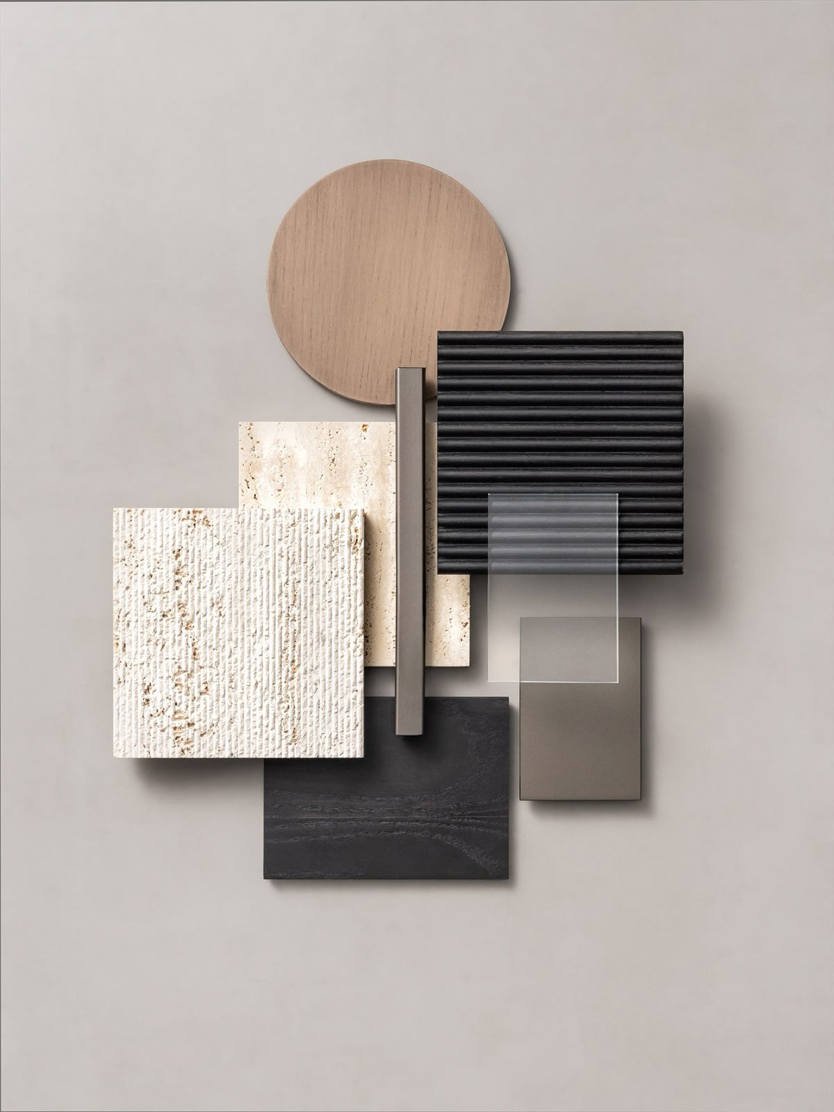 Flat lay of various textured and colored material samples including wood, stone, ribbed black square, gray, and transparent pieces arranged on a light background.