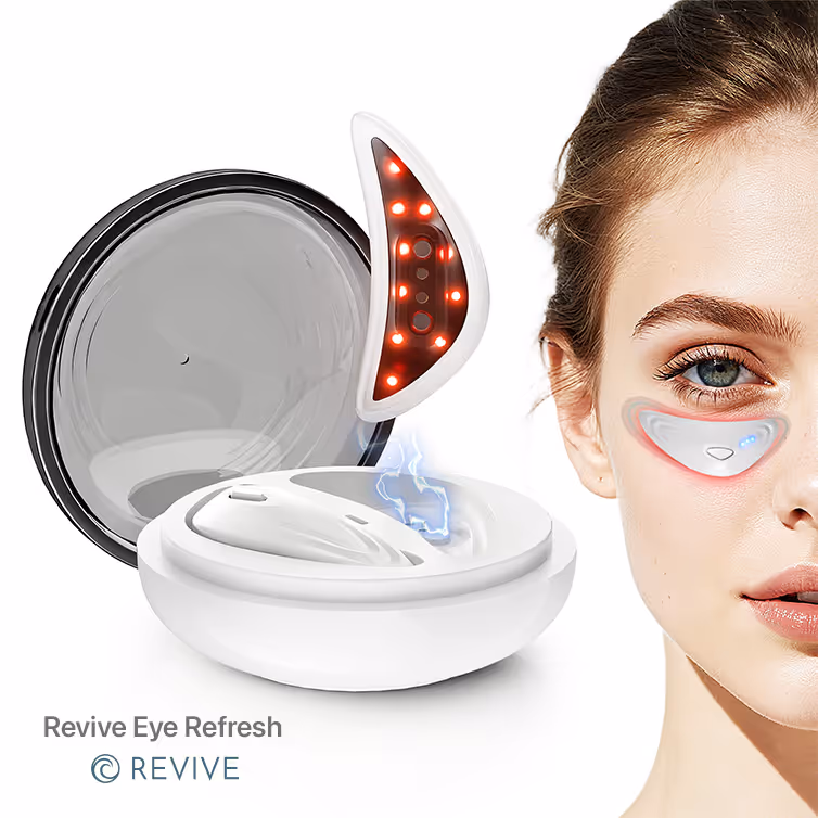 Close-up of a woman using a Revive Eye Refresh device, shown as a curved eye patch with blue indicator lights under her eye and a white charging case with a glowing red light panel.