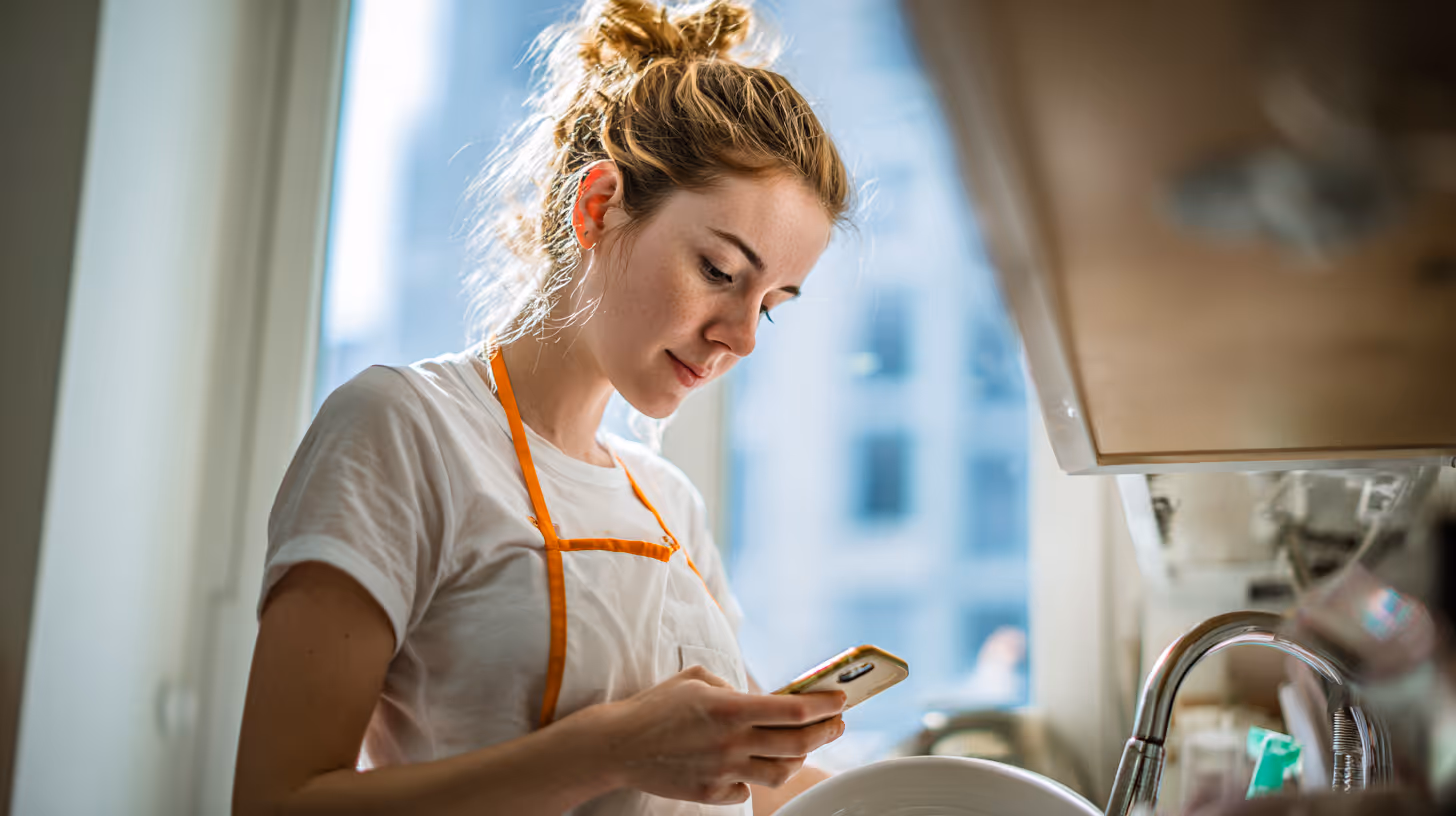 happy Airbnb staff working through her phone