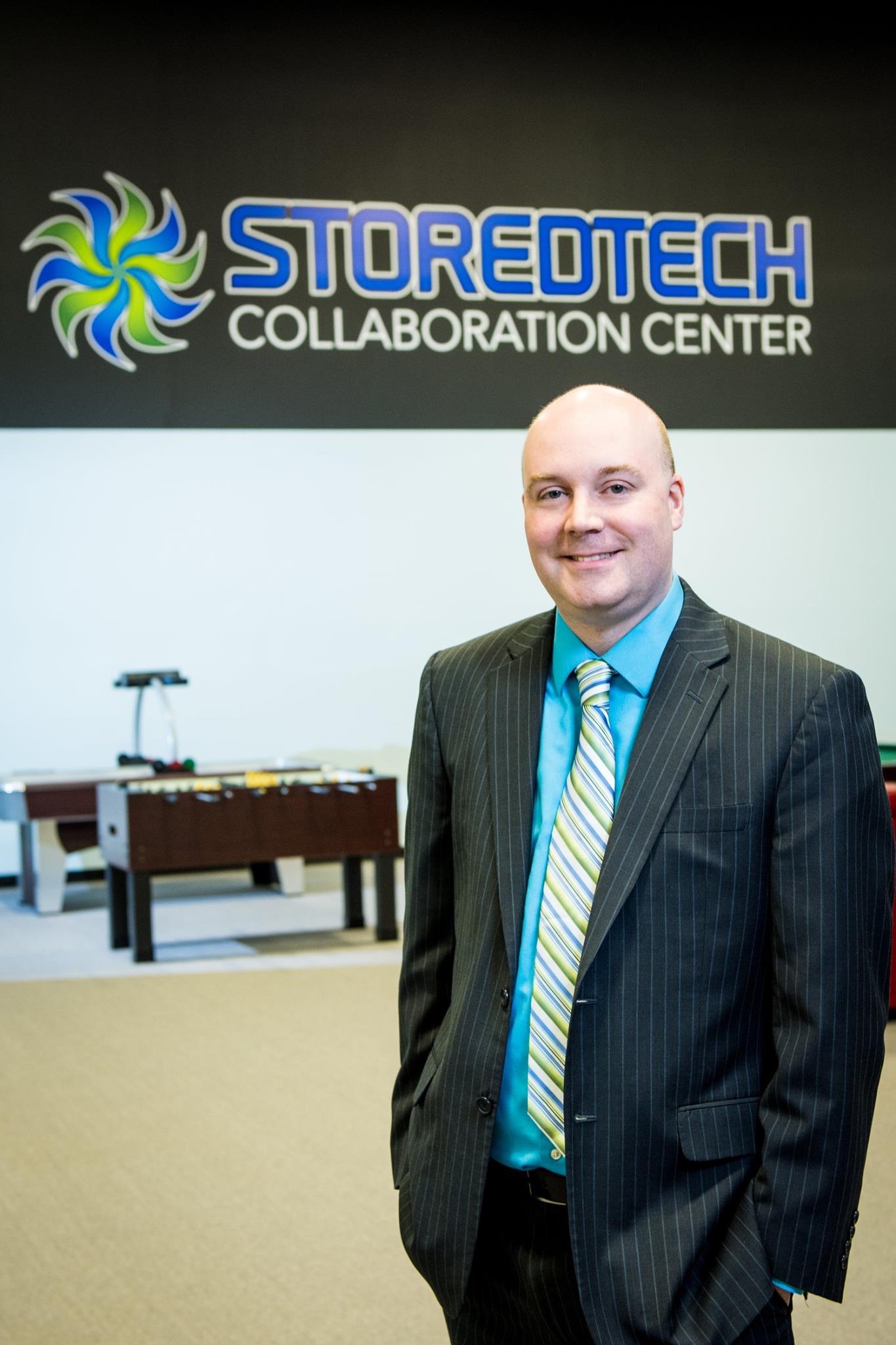 Mark Shaw pictured with StoreTech Logo in the background