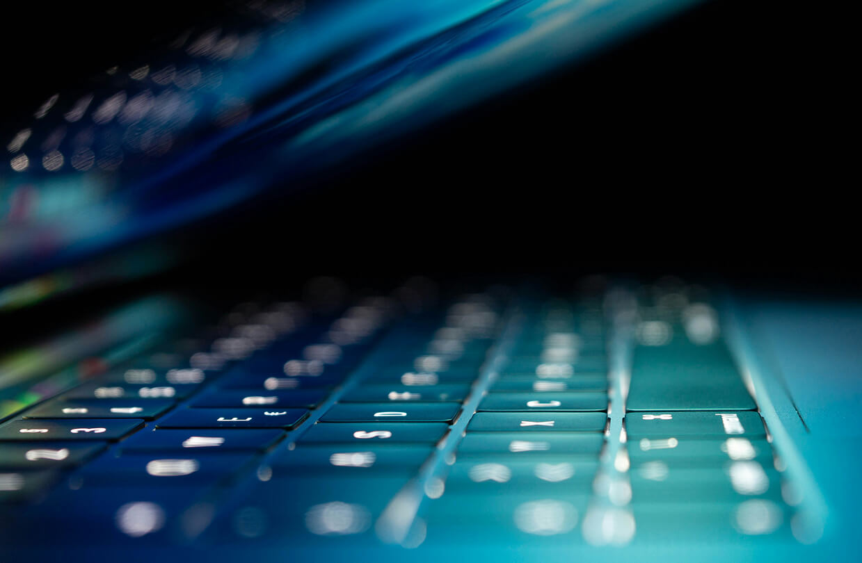 Light shining through a half open laptop