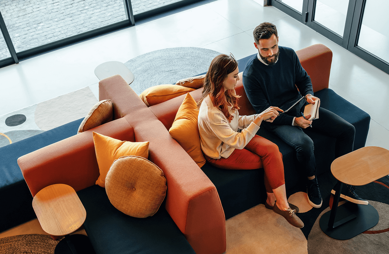 High angle view of two business colleagues working in a lobby