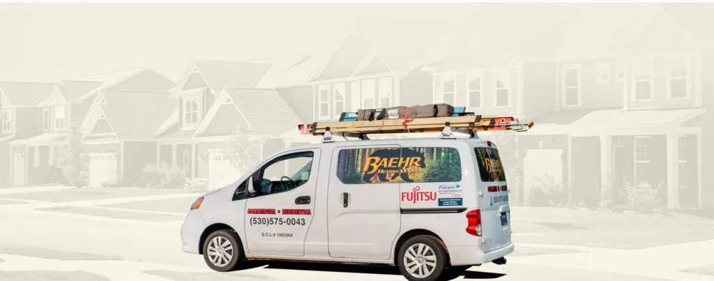 White service van with Baehr Heating & Air and Fujitsu branding parked in front of suburban houses.