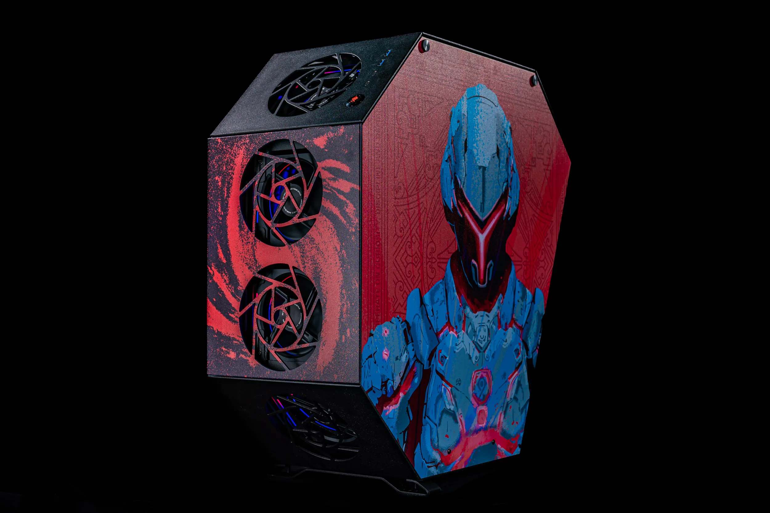Custom polygon-shaped PC case featuring blue and red futuristic robot artwork and two glowing fans on a red swirl background, against black backdrop.
