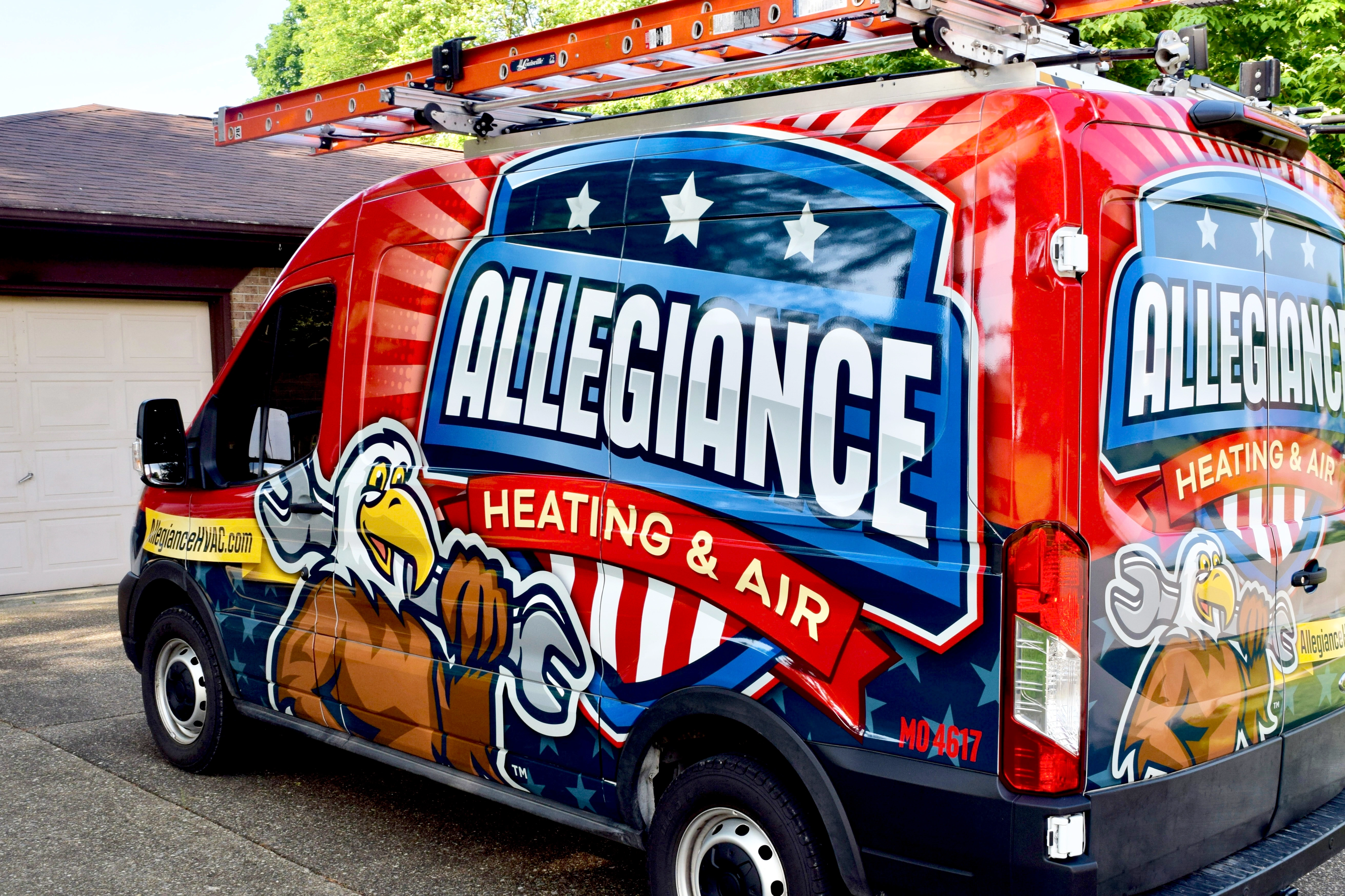 Red van with "Allegiance Heating & Air" logo, featuring an eagle with a wrench and American flag details