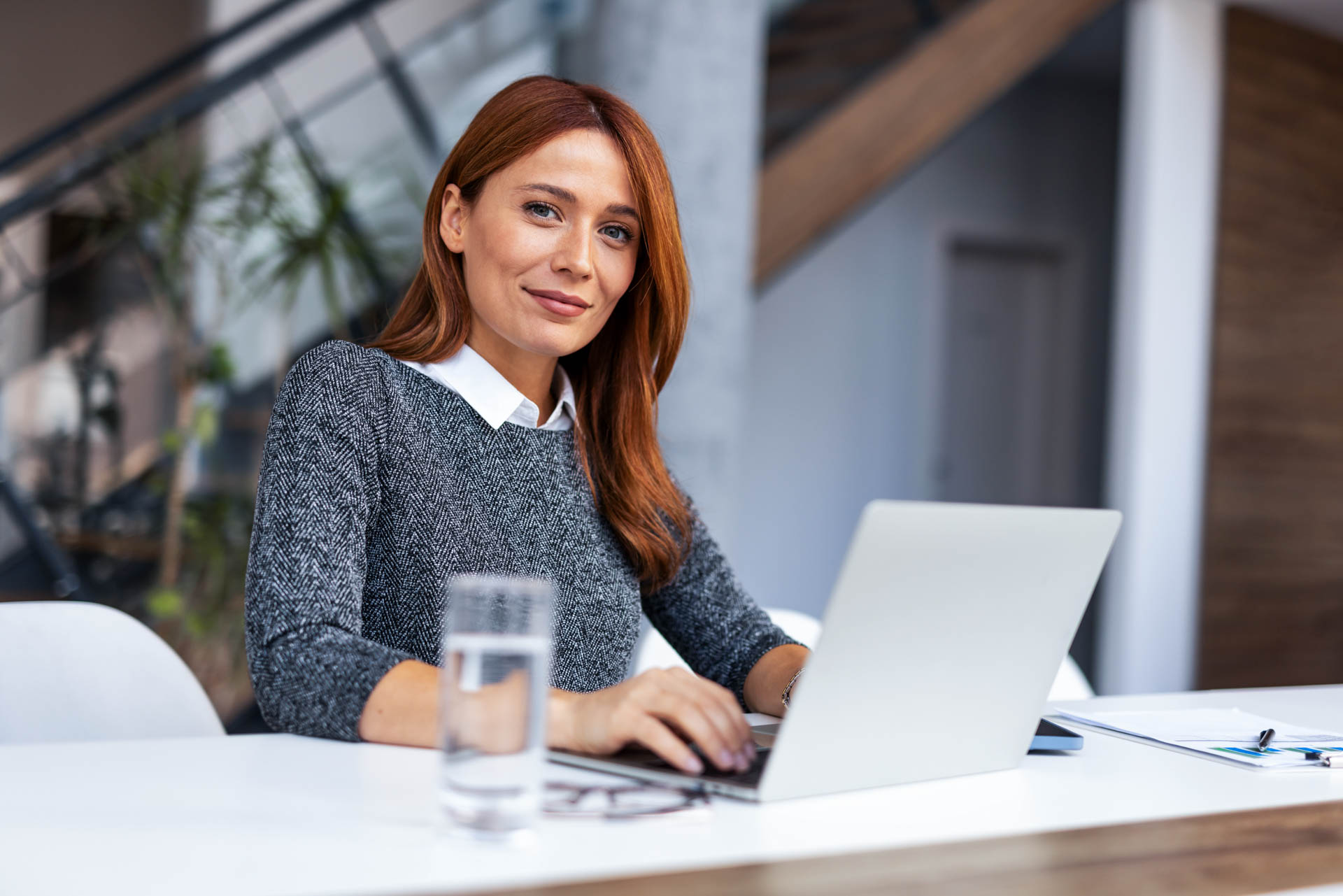 a women working on a laptop in a modern office