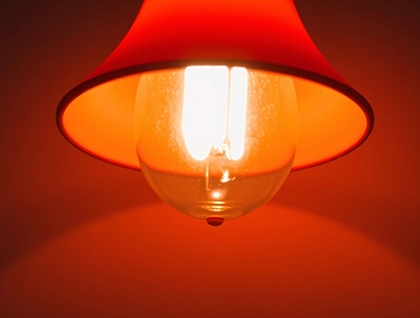 Light Bulb In Red LampShade