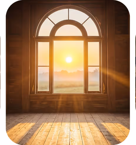 Sunlight streaming through a large arched window onto a wooden floor inside a room.