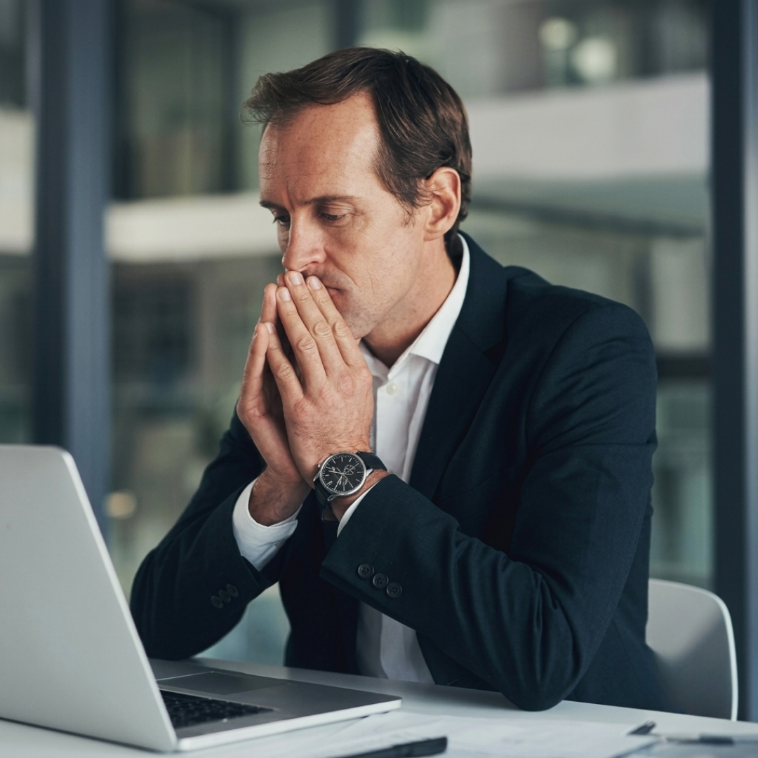 An executive working alone in a dim office at night