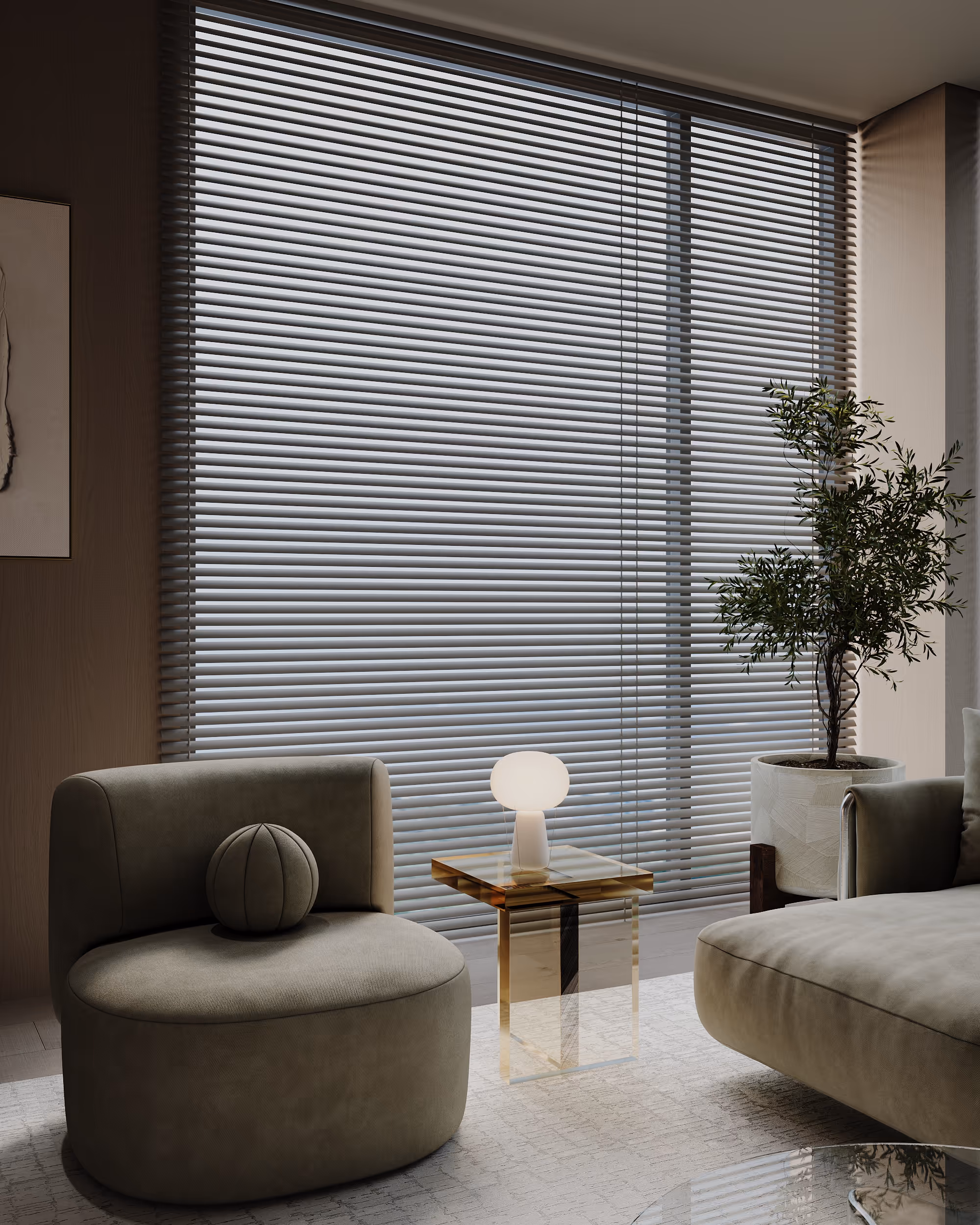Modern living room corner with beige armchair, transparent side table with a small white lamp, large window with horizontal blinds, and a potted plant.