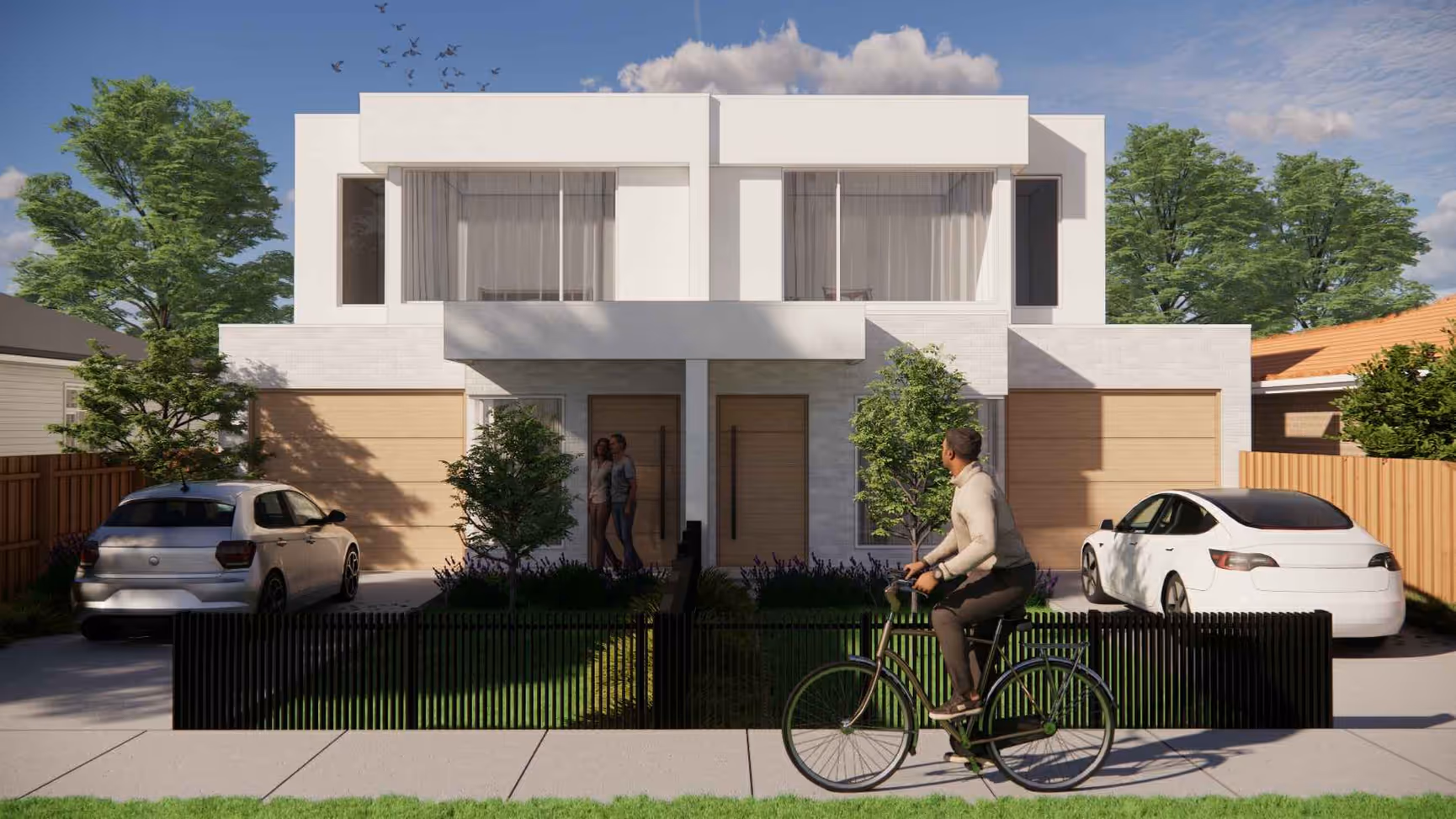 Modern duplex with two wooden garages, a man riding a bicycle in front, and a couple standing at one entrance.