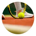 Close-up of a tennis racket hitting a tennis ball on a clay court near the net line.