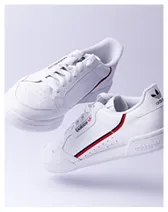 Pair of white Adidas Continental 80 sneakers with red and navy stripes on the side.
