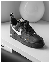 Black Nike Air Force 1 sneaker with white swoosh logo displayed on a white surface.