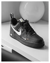 Black Nike Air Force 1 sneaker with white swoosh logo displayed on a white surface.