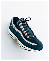 Black and pink athletic sneaker with white sole on a white background.