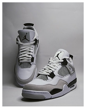 Pair of white and grey Air Jordan 4 sneakers with black accents against a neutral background.