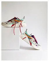 Pair of colorful sneakers with red and purple laces displayed against a plain white background.