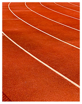 Curved lanes of a red running track with white lines.