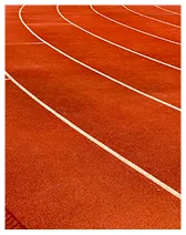 Curved lanes of a red running track with white lines.